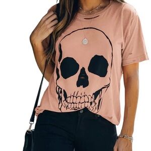 Women’s size small skull shirt. Color is an apricot/beige. Great for Halloween